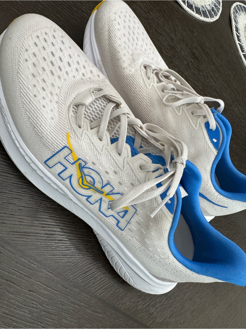 Hoka White Athletic Running Shoes with Blue and Yellow Accents